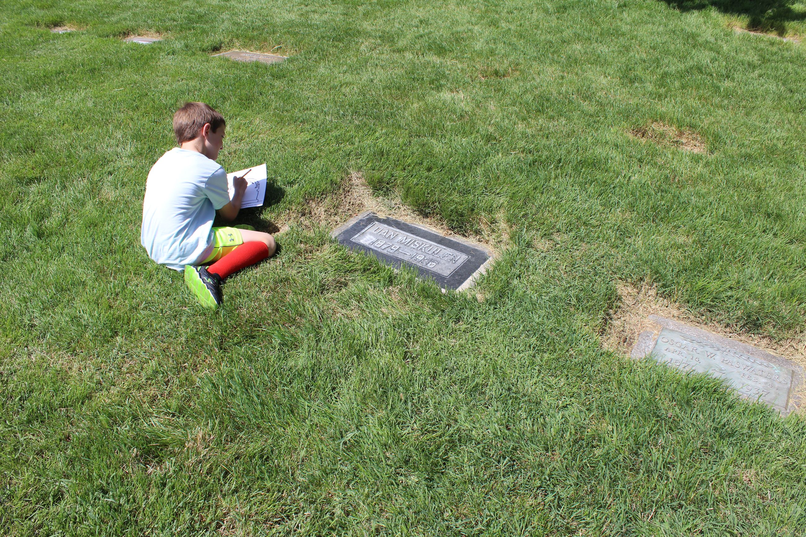 Child Drawing a Headstone